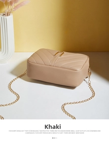 Detail view of khaki quilted crossbody bag with golden chain and V-pattern texture