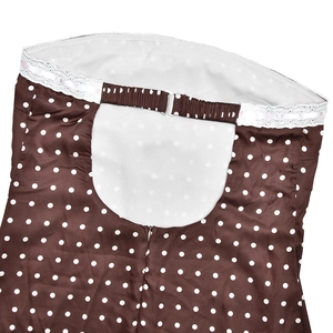 Detailed back view of a polka dot dress with white lace trim and metallic buckle closure