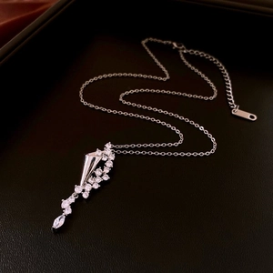Detail of silver waterdrop necklace with shimmering cubic zirconia on dark background