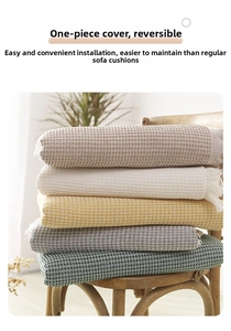Detail of waffle weave sofa covers with fringe in multiple colors on a wooden chair
