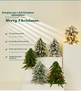 Detail of mini desk Christmas tree with warm LED lights and Nordic flocking design