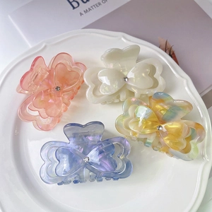 Elegant butterfly acetate hair claws with marble texture and rhinestone heart detail