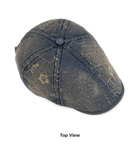 Top view of vintage blue washed denim newsboy hat with intricate floral embroidery details