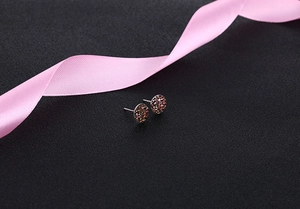 Macro detail of round S925 silver studs with multi-color shimmering crystal clusters