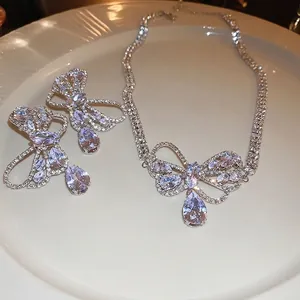 Elegant silver bow jewelry set with zircon drop pendants including necklace and earrings