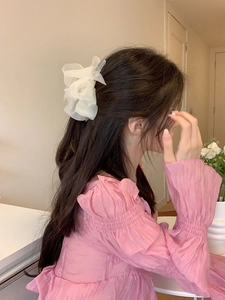 Elegant white mesh flower hair claw clip displayed on a model's hair from the side