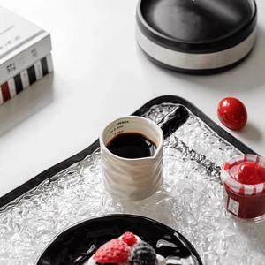 White ceramic coffee creamer pitcher with black handle and 3oz/90ml capacity scale