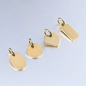 Detailed view of polished gold stainless steel pendants in various geometric shapes