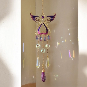Detail of angel suncatcher with purple crystals and rainbow light reflections