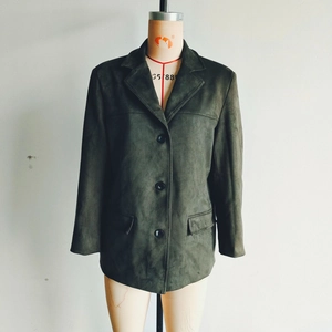 Detail of dark green faux suede blazer with three buttons and flap pockets on a mannequin