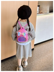 Pink patent leather backpack for girls featuring a large sequin bow and cute ears