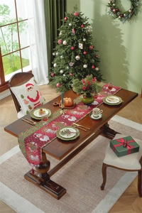 Detailed pattern of a red Christmas table runner with Santa, snowman and reindeer motifs