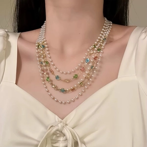 Detail of multi-layer necklace with white pearls and colorful crystal beads for women