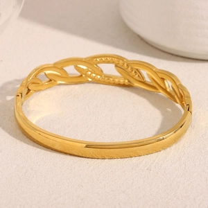 Close-up of 18K gold plated bangle featuring a detailed woven texture and metal finish