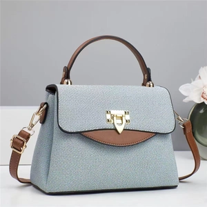 Contrast print canvas tote bag with brown leather handles and gold triangle clasp