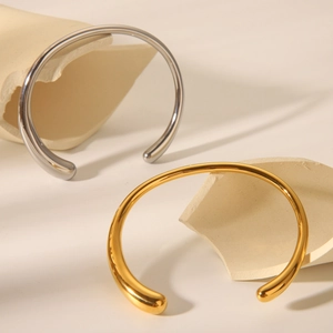 Minimalist C-shaped polished titanium steel bangles in gold and silver finish