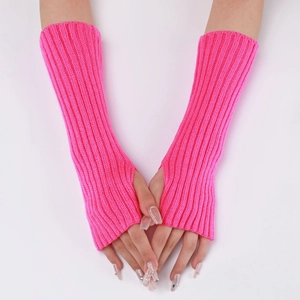 Detail of neon pink knitted fingerless gloves showing ribbed texture and thumb hole