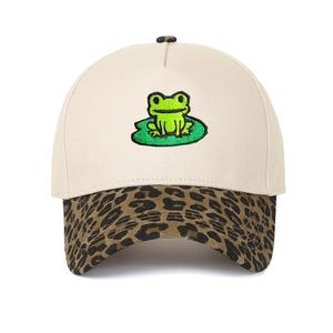 Detailed embroidery of a green frog on a lotus leaf with a leopard print visor