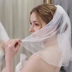 Short white bridal wedding veil with sparkling rhinestones and delicate mesh tulle