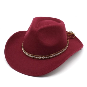 Detail of wine red felt cowboy hat featuring rhinestone and metal stud decorative band