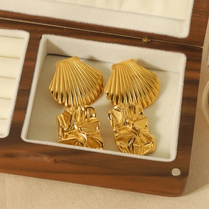 Golden shell texture and irregular molten metal drop earrings in a wooden jewelry box