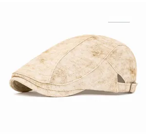 Detail of khaki vintage newsboy hat featuring washed texture and side metal buckle