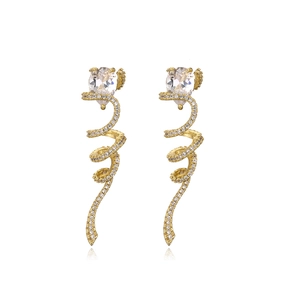 Detailed macro shot of gold-plated spiral earrings with sparkling teardrop zircons