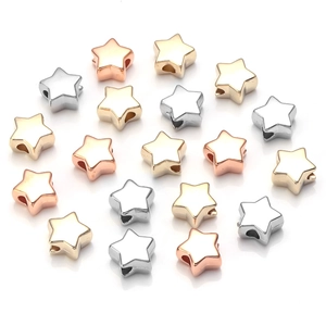Macro shot of gold and silver star-shaped spacer beads with large holes for DIY jewelry