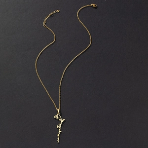 Detail of gold stainless steel flower pendant with lobster clasp and extension chain