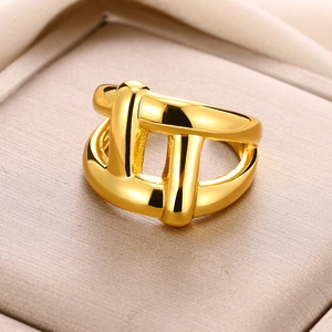 Macro view of gold-plated double-layer geometric knotted ring in premium gift box