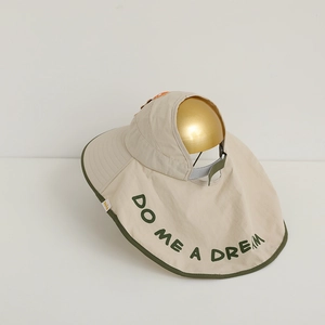 Detail view of adjustable velcro strap and neck protection on beige kids sun hat