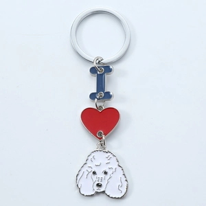 Detail view of poodle charm with red heart and letter I on metal keychain