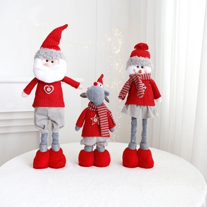 Three plush Christmas figurines of Santa, Reindeer, and Snowman on a white table
