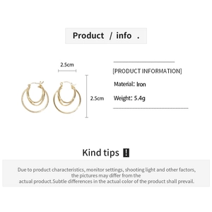 Detail showing 2.5cm triple-layered golden hoop earrings with material and weight specs