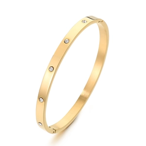 Minimalist gold stainless steel round bangle with sparkling rhinestones on white background