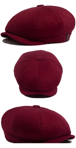 Close-up of wine red baker boy hat with cotton twill fabric and leather decorative label