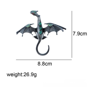 Detailed view of vintage dragon brooch with green crystals and 8.8cm by 7.9cm dimensions