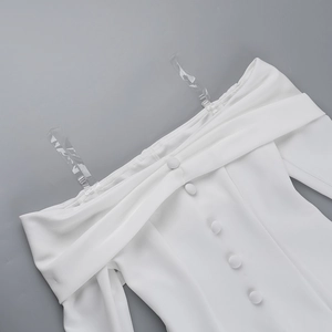 Detail of off-shoulder dress with transparent straps and matching white decorative buttons