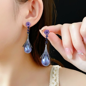 Detail of purple teardrop earrings with floral diamond stud and imitation pearl dangle