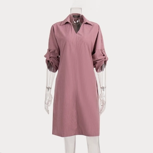 Detail view of pink corduroy dress with adjustable buttoned sleeves and textured fabric