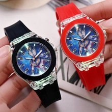 Close-up of glowing Ultraman cartoon kids watch with red and black silicone straps