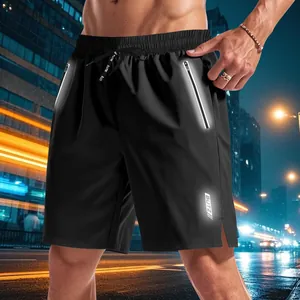Detail of reflective zipper pocket on men's quick-dry sports shorts for night running