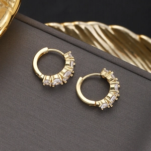 Detail shot of 18K gold plated hoop earrings with shimmering clear cubic zirconia stones