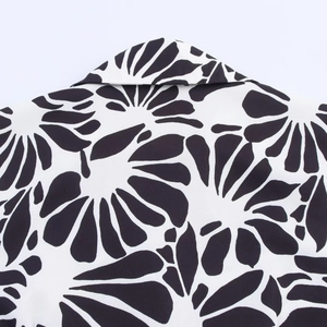 Close-up of black and white floral print halter dress collar with precise stitching detail