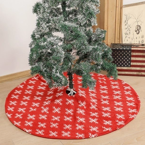Red Christmas tree skirt with white snowflake patterns on a soft plush fabric base