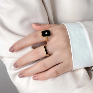 French style gold square ring with black enamel and diamond worn on model finger