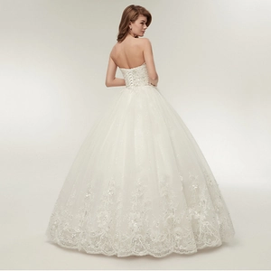 Elegant white strapless floor-length wedding dress with lace embroidery and lace-up back