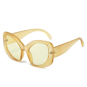 Fashionable amber yellow oversized wrap sunglasses with chunky frames and side profile view