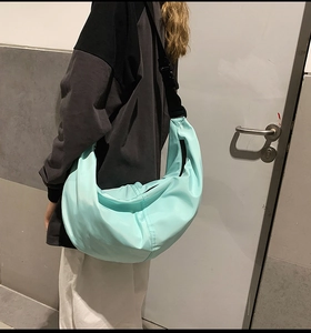 Light blue nylon crescent bag with adjustable strap and large capacity design