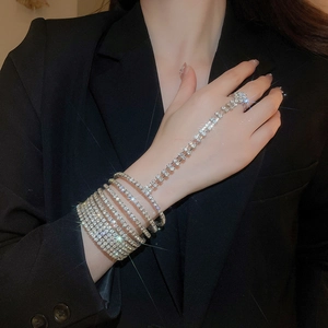 Close-up of elegant multi-layer rhinestone hand harness with silver linked finger ring